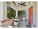 Inviting front porch featuring a seating area, brick accents, and a decorative ceiling fan at 2592 Valley Stream Dr, Atlanta, GA 30360