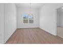 Well-lit dining room with hardwood floors and a large window at 1209 Cedarcrest Blvd, Acworth, GA 30101