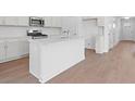 Modern kitchen with white cabinets, stone countertops and an island at 1209 Cedarcrest Blvd, Acworth, GA 30101