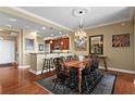 Elegant dining room with hardwood floors, chandelier, and a large table with seating for eight at 2950 Mount Wilkinson Se Pkwy # 712, Atlanta, GA 30339