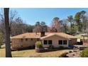 Back exterior view of a brick home with a wooden deck and spacious backyard, perfect for outdoor living at 3401 Doyle Sw Ln, Marietta, GA 30060