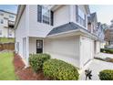 Townhome featuring garage, verdant lawn, and welcoming entrance with a small patio at 6730 Gallant Se Ct, Mableton, GA 30126