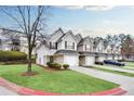 View of townhomes with attached garages, manicured lawns, and convenient parking at 6730 Gallant Se Ct, Mableton, GA 30126