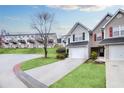 Charming townhome with a one-car garage, a manicured lawn, and a paved driveway at 6730 Gallant Se Ct, Mableton, GA 30126