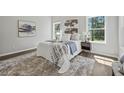 Bright bedroom featuring multiple windows, neutral decor, and hardwood floors at 6971 Tan Bark Ct, Riverdale, GA 30296