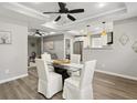 Bright dining area with modern table set, ceiling fan, and easy access to the kitchen at 1406 Kennesaw Nw Dr, Atlanta, GA 30318