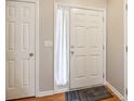 Bright entryway features a white front door with a storm door and a white closet door at 1624 River Main Ct, Lawrenceville, GA 30046