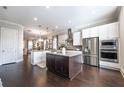 Spacious kitchen with a large center island, stainless steel appliances, and sleek white cabinets at 1384 Doublegate Dr, Brookhaven, GA 30319