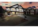 Beautiful two-story home with manicured lawn, and a two-car garage at sunset at 5470 Beaver Ridge Dr, Cumming, GA 30040