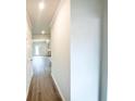 Bright hallway featuring wood-look flooring leading into an open concept living space at 5518 Legacy Trl, Douglasville, GA 30135