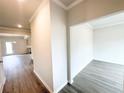 Open hallway with wood-look flooring with an entryway to a bedroom or office at 5518 Legacy Trl, Douglasville, GA 30135