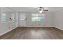 Bright living room with light-colored walls, new floor and ceiling fan, and ample natural light from a window at 2892 Cardinal Lake Dr, Duluth, GA 30096