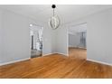 Open dining room with hardwood floors and modern light fixture at 700 Bayliss Dr, Marietta, GA 30068