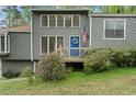 View of the home's entrance featuring a blue door decorated with a wreath and an American flag at 700 Bayliss Dr, Marietta, GA 30068