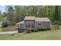 Charming gray two-story home with a well-maintained lawn and a wooden fence in the backyard at 700 Bayliss Dr, Marietta, GA 30068