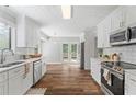 Bright kitchen featuring white cabinets, stainless steel appliances, and modern countertops at 700 Bayliss Dr, Marietta, GA 30068