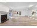 Open-concept living space featuring fireplace, hardwood floors, and mirrored wall at 73 Rumson Se Ct, Smyrna, GA 30080