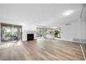 Spacious living room with fireplace, light wood floors, and sliding glass doors to patio at 73 Rumson Se Ct, Smyrna, GA 30080