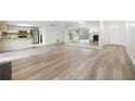 Open-concept living area showcasing hardwood floors, mirrored wall, and a view of the kitchen at 73 Rumson Se Ct, Smyrna, GA 30080