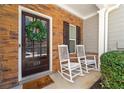 Charming front porch featuring a decorative wreath and rocking chairs at 1119 Brownstone Dr, Marietta, GA 30008