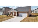 Beautiful single Gathering home with brick accents and a two car garage at 6902 Winchester Pl, Fairburn, GA 30213