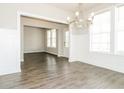 Dining area with hardwood floors, lots of natural light and modern chandelier at 1340 Slaton Manor Dr, Conyers, GA 30012
