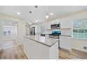 Modern kitchen featuring an island, stainless steel appliances, and sleek countertops at 1467 Thompson Pl, Decatur, GA 30032