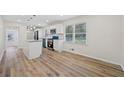 Open kitchen with island, stainless appliances, and new wood floors at 1467 Thompson Pl, Decatur, GA 30032