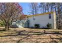 Light colored single story home featuring a deck and ample yard space at 1640 Trails Way, Marietta, GA 30066