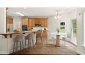 Well-lit kitchen featuring a breakfast bar and adjacent dining area at 3932 E Saddle Ridge Dr, Lithonia, GA 30038