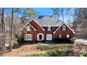 Beautiful two-story red brick home with black shutters and a well-maintained front yard at 5679 Brookstone Nw Walk, Acworth, GA 30101