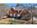 Charming brick home features a well-maintained lawn, mature trees, and a welcoming front entrance at 5679 Brookstone Nw Walk, Acworth, GA 30101