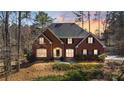 Attractive brick home with a well-maintained lawn, mature trees, and welcoming front entrance at 5679 Brookstone Nw Walk, Acworth, GA 30101