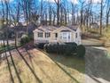 Charming home boasts a well-manicured lawn, stone accents, and inviting front porch with stairs at 1184 Broward Ne Dr, Marietta, GA 30066