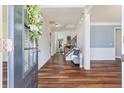 Inviting foyer with wood flooring, decorative wreath on the front door, and view of the staircase at 133 Abbey Pointe Way, Suwanee, GA 30024