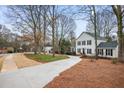 Exterior view of a two story home with dark shutters, fresh landscaping, and a long driveway at 2828 Saddlebrook Nw Way, Marietta, GA 30064