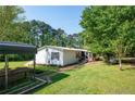 Single-story home with accessible ramp and screened porch, nestled in a lush, green yard at 291 Folsom Glade Rd, Rydal, GA 30171