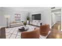 Staged living room with contemporary furniture, rug, and mounted TV at 3187 Abbeywood Dr, Decatur, GA 30034