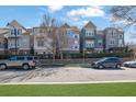 Exterior street view of modern townhomes with well-manicured lawns and mature trees at 108 Blakemore Se Dr, Smyrna, GA 30080