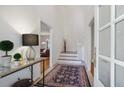 Welcoming foyer with high ceilings, stylish console table, and view of staircase sets an elegant tone at 17 Blackland Rd, Atlanta, GA 30342