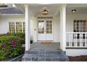Inviting front porch with double doors, slate tile, white columns, and colorful landscaping creates a warm welcome at 17 Blackland Rd, Atlanta, GA 30342