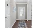 Light-filled entryway boasting hardwood floors, a patterned rug, and a glass-paneled door for a bright and inviting entrance at 525 Lanier Way, Temple, GA 30179