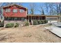 Inviting two-story home boasts mature landscaping, traditional windows, and an attached garage at 6067 Dana Dr, Norcross, GA 30093