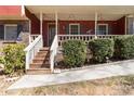 Welcoming front porch features detailed railings, string lights, and well-maintained landscaping at 6067 Dana Dr, Norcross, GA 30093