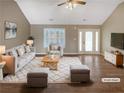 Bright living room showcasing modern decor, wood floors, and large windows at 21 Fortson Dr, Hampton, GA 30228