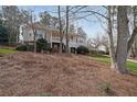 Charming two-story home with a front yard covered in pine straw and mature trees at 3114 Superior Dr, Dacula, GA 30019