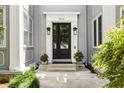 Charming front entrance with black double doors, stylish lighting, and manicured landscaping at 435 10Th Ne St # 18, Atlanta, GA 30309