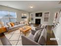 Cozy living room featuring a fireplace, large windows, and stylish neutral-toned furniture at 272 Laurel Canyon Pkwy, Canton, GA 30114