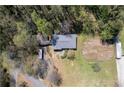 Aerial view of home featuring mature trees, detached garage, and a cultivated garden area at 4693 Sugar Hill Se Rd, Acworth, GA 30102