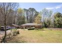 A single-story brick home with a large front yard, RV, and detached garage at 4693 Sugar Hill Se Rd, Acworth, GA 30102